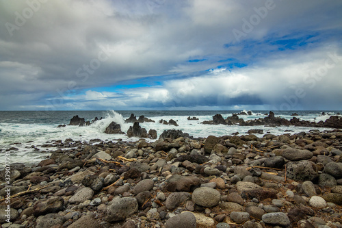 Beautiful shore. Large boulder among the waves in the sea. Hawaii