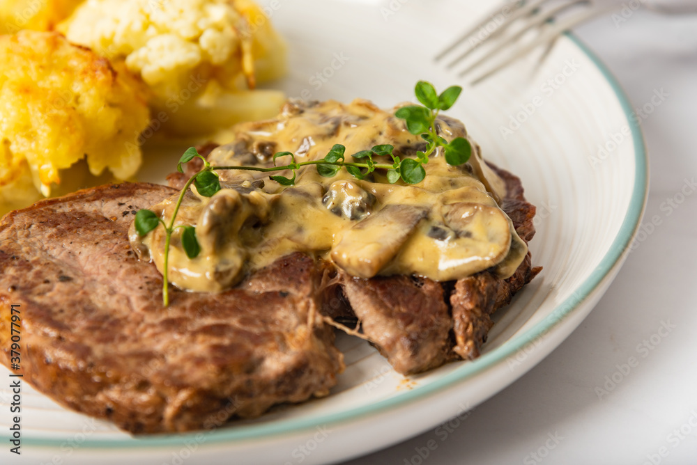 Eye fillet served with cauliflower gratin and mushroom sauce Eye fillet served with cauliflower gratin and mushroom sauce