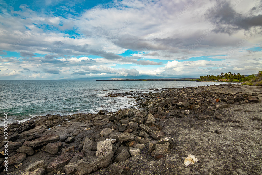 Beautiful shore. Large boulder among the waves in the sea. Hawaii