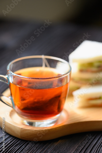 Fototapeta Naklejka Na Ścianę i Meble -  Hot Tea with Tuna Sandwich on wooden plate