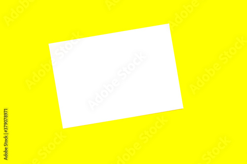 Blank sheet of white paper on yellow background.