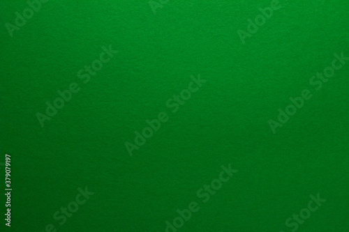 Green background. Sheet of blank green paper with texture, close up.