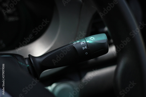 Switch off lights in a car. close-up Car integrated turning indicator with headlight switch toggle.