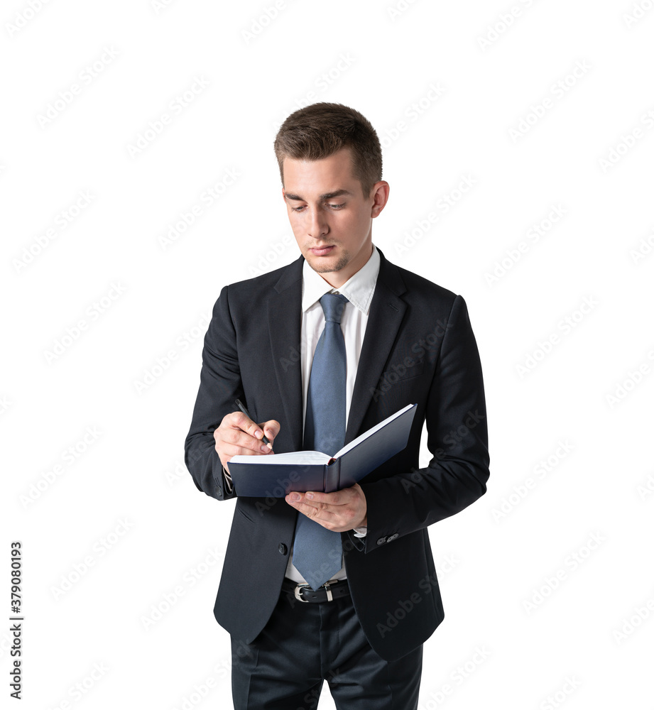 Young businessman writing in notebook, isolated Young businessman writing in notebook, isolated