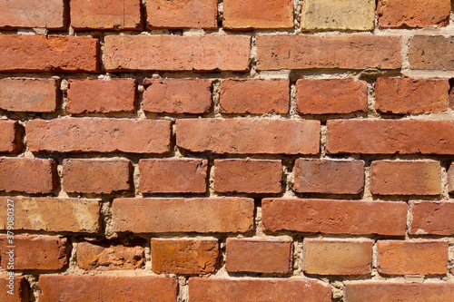 The wall of a building or structure made of red brick. Background, texture.