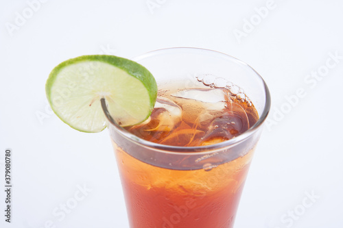 glass of ice tea with lemon on the white background