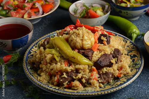 Uzbek cuisine (food) pilaf (plov palov osh) salad achichuk (achuchuk).Mutton,rice,carrots,vegetable oil,raisins,onion,turmeric,black pepper,cumin