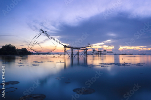 Scene of beautiful sunrise in the morning and giant square dip net at Pakpra village, Phatthalung, Thailand