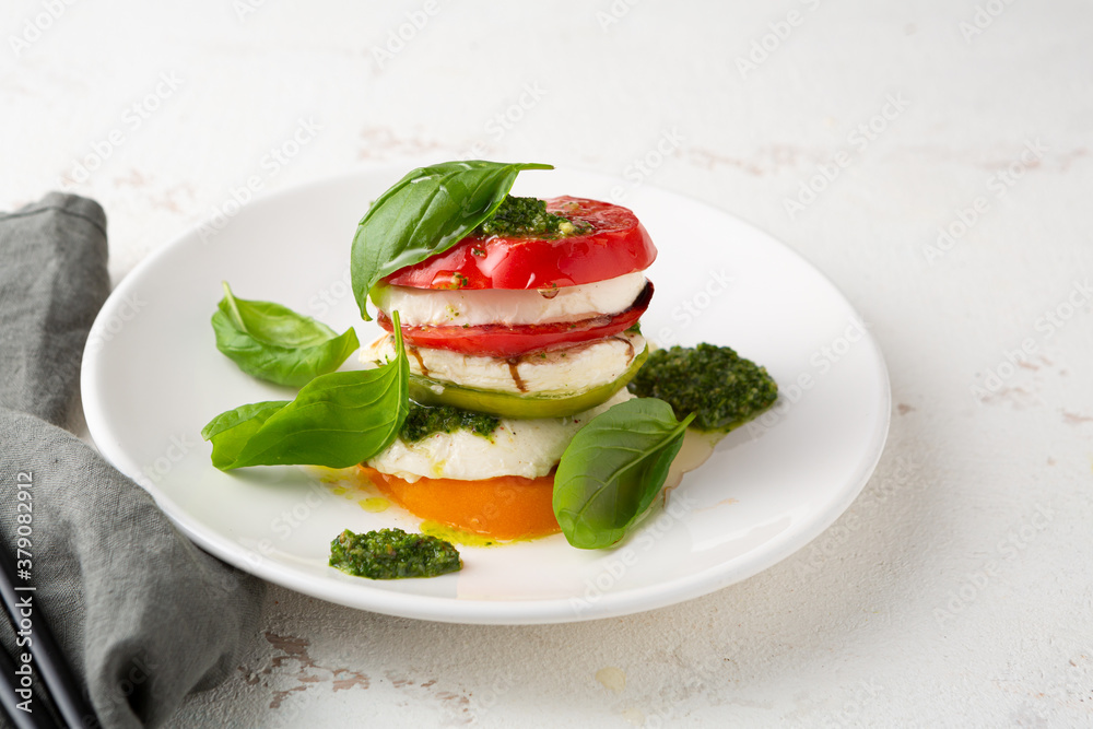 Summer caprese salad on white plate