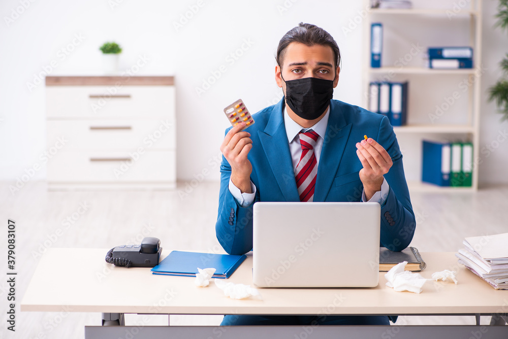 Sick male employee suffering at workplace from coronavirus Sick male employee suffering at workplace from coronavirus