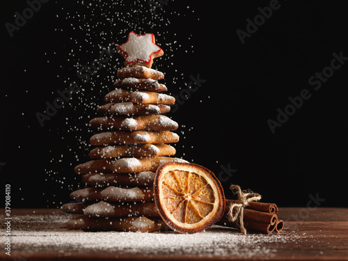 Christmas gingerbread cookies and spices on wooden background. Close-up