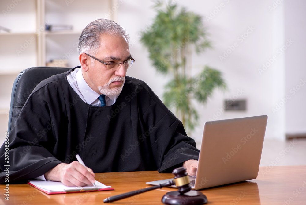 Old male judge working in courthouse Old male judge working in courthouse
