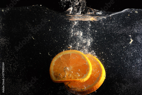 Water drops on ripe sweet orange. Fresh mandarin background with copy space for your text. Vegetarian concept. photo