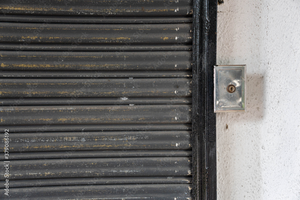Closed steel shutter with its lock during lock down