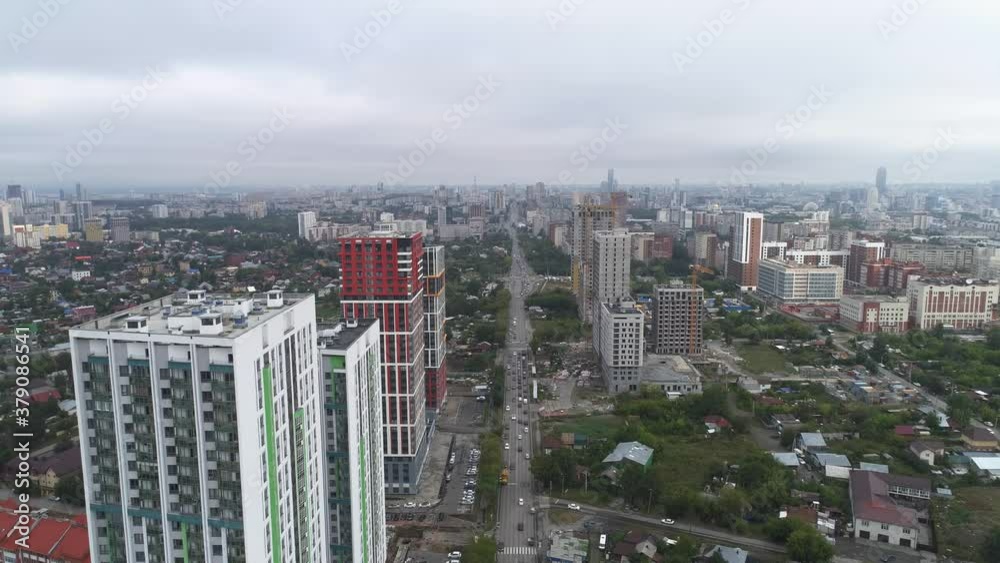 Aerial view of Car traffic in city. Cloudy summer morning. There are new high-rise buildings and houses under construction with tower cranes
Aerial view of Car traffic in city. Cloudy summer morning. There are new high-rise buildings and houses under construction with tower cranes