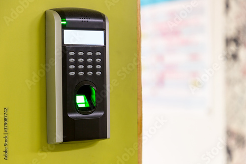 Finger scan on machine Security concept and safety. soft focus on hand scanning finger on machine concept. Businessman hand scanning finger on machine, Technology concept or Business concept.