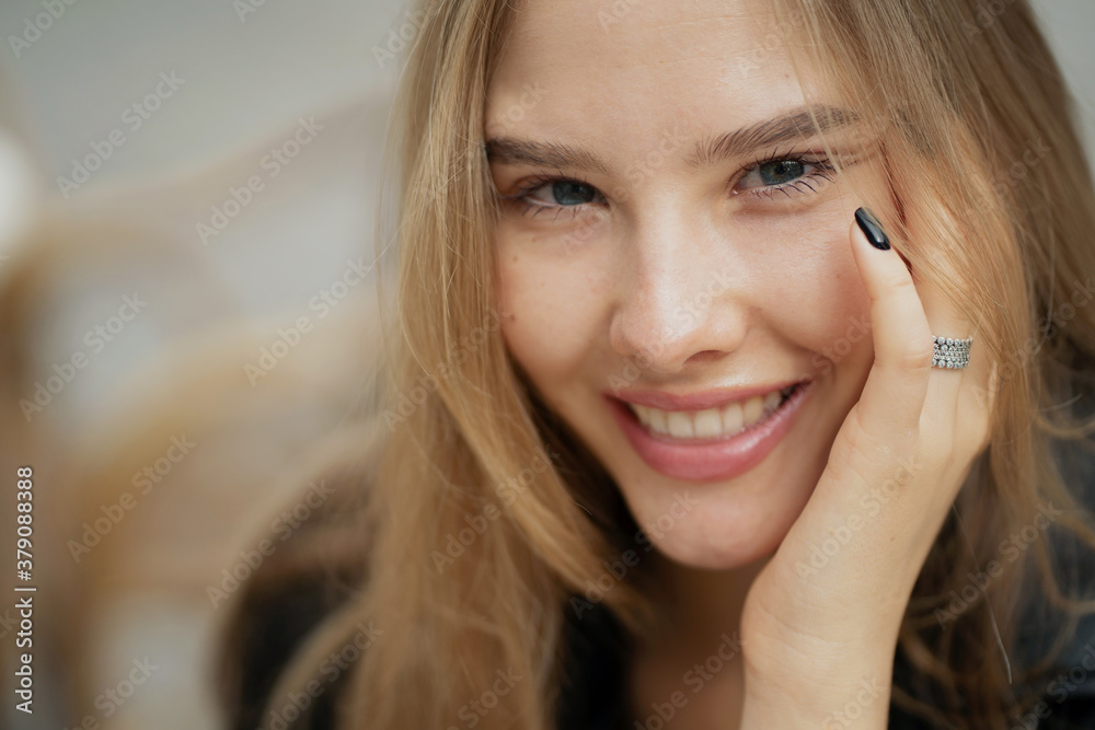 Fototapeta premium Close portrait of a young woman smiling