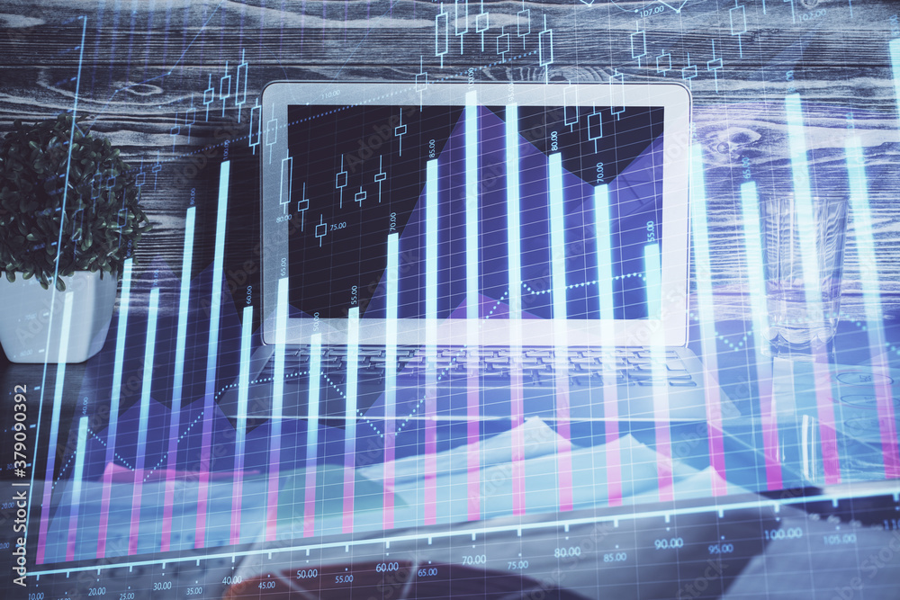 Financial graph colorful drawing and table with computer on background. Double exposure. Concept of international markets. Financial graph colorful drawing and table with computer on background. Double exposure. Concept of international markets.