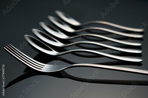 Fork and teaspoons lie on a glass table