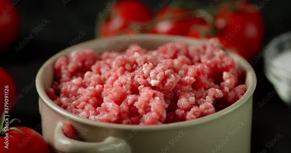 Bowl with raw minced meat slowly rotates. Bowl with raw minced meat slowly rotates.