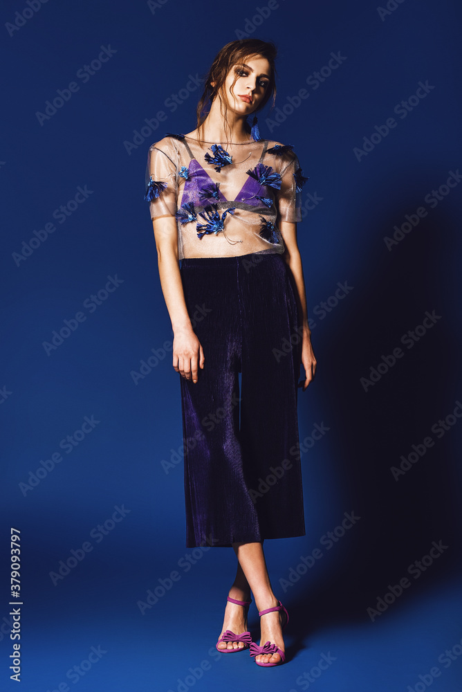 Stylish woman in plisse pants and floral top Stylish woman in plisse pants and floral top