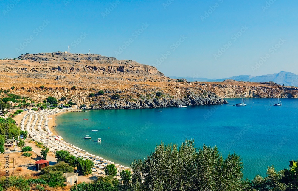 Gulf and beach at the foot of the acropolis. The city of Lindos, Greece.