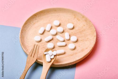 Assorted pharmaceutical medicine, Taking too much medication pills on spoon, Overdiagnosis drugs cause bad health. photo