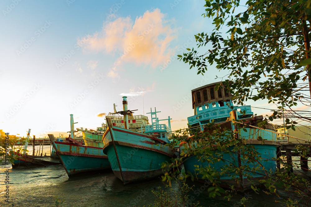 Beautiful majestic sunrise by the lakeside with fishing boats. Nature landscape