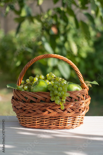 basket with grapes and apples