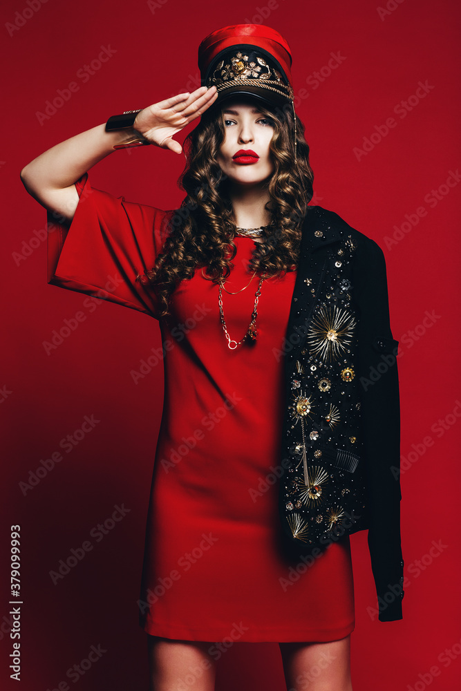 woman in red uniform makes a formal salute