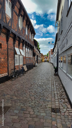 Street with old houses in a town in Denmark © AdobeTim82