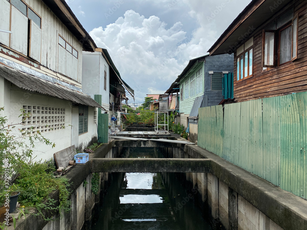 Small cancel passing between houses in Bangkok Small cancel passing between houses in Bangkok