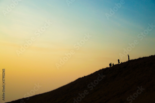 Fototapeta Naklejka Na Ścianę i Meble -  silhouette of a person on a mountain top