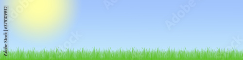 Landschaft mit grüner Wiese und blauem Himmel mit Wolken und Sonne