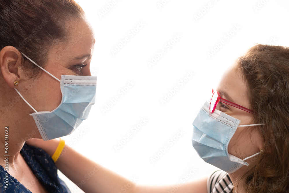 woman and girl face each other with covid19 mask