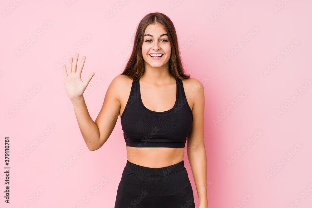 Young caucasian fitness woman doing sport isolated smiling cheerful showing number five with fingers.
