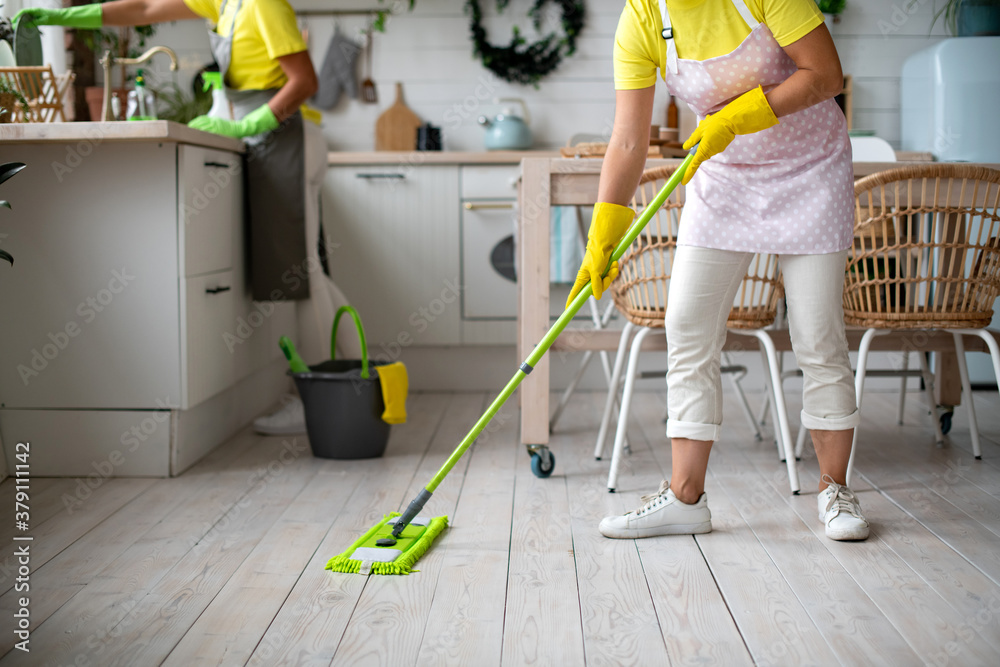 Two housemaids are cleaning the kitchen. General cleaning of the house