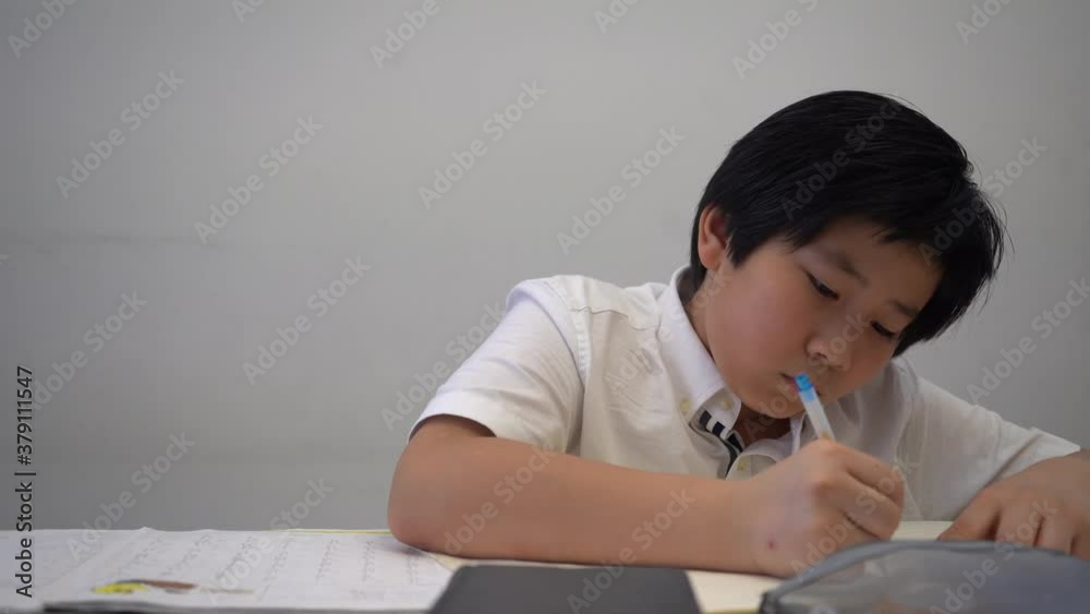 Asian Boy doing homework and study so hard Asian Boy doing homework and study so hard