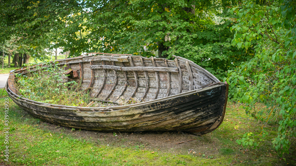 Old, wooden, abandoned boat lying in forest. Old, wooden, abandoned boat lying in forest.