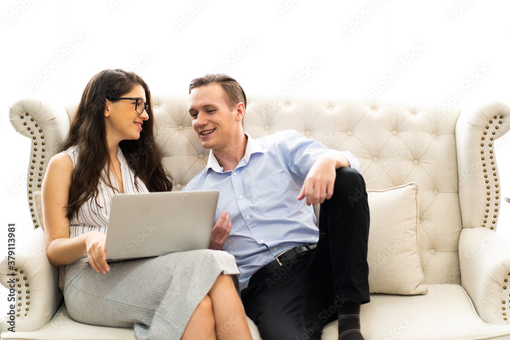 Young caucasian couple using laptop computer at home..shopping online at home. couple planning a trip abroad on their wedding anniversary Young caucasian couple using laptop computer at home..shopping online at home. couple planning a trip abroad on their wedding anniversary
