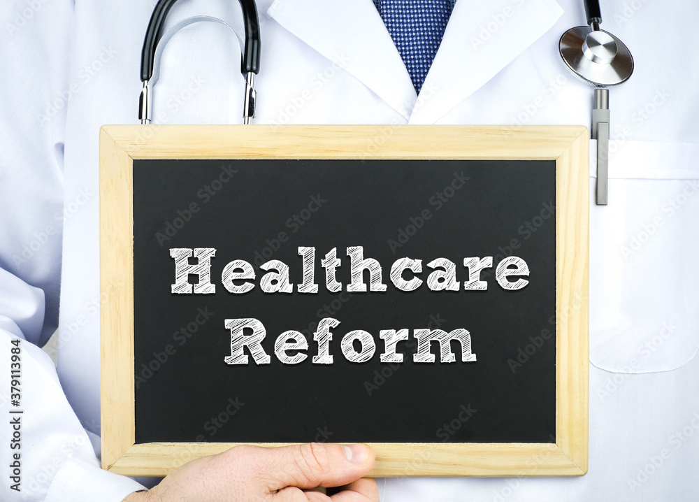 Doctor holding chalkboard with the message Healthcare Reform Doctor holding chalkboard with the message Healthcare Reform