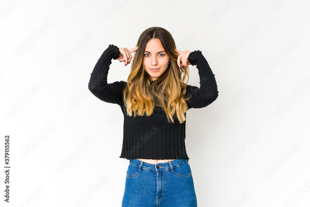 Young caucasian woman isolated on white background focused on a task, keeping forefingers pointing head. Young caucasian woman isolated on white background focused on a task, keeping forefingers pointing head.