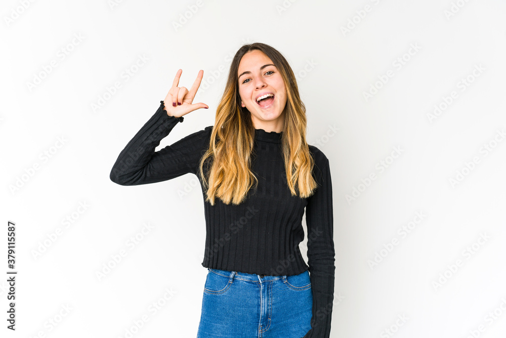 Young caucasian woman isolated on white background showing a horns gesture as a revolution concept. Young caucasian woman isolated on white background showing a horns gesture as a revolution concept.