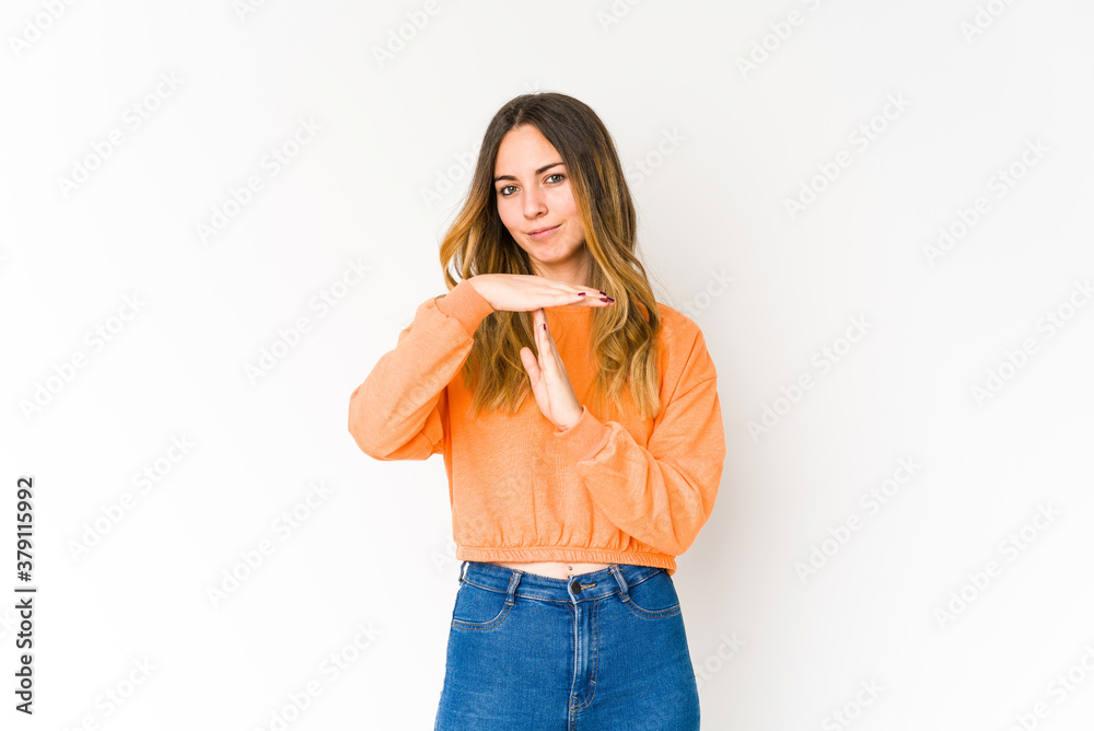 Young caucasian woman isolated on white background showing a timeout gesture. Young caucasian woman isolated on white background showing a timeout gesture.