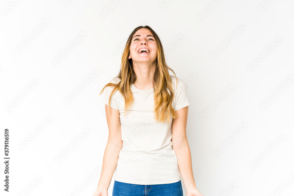 Young caucasian woman isolated on white background relaxed and happy laughing, neck stretched showing teeth. Young caucasian woman isolated on white background relaxed and happy laughing, neck stretched showing teeth.