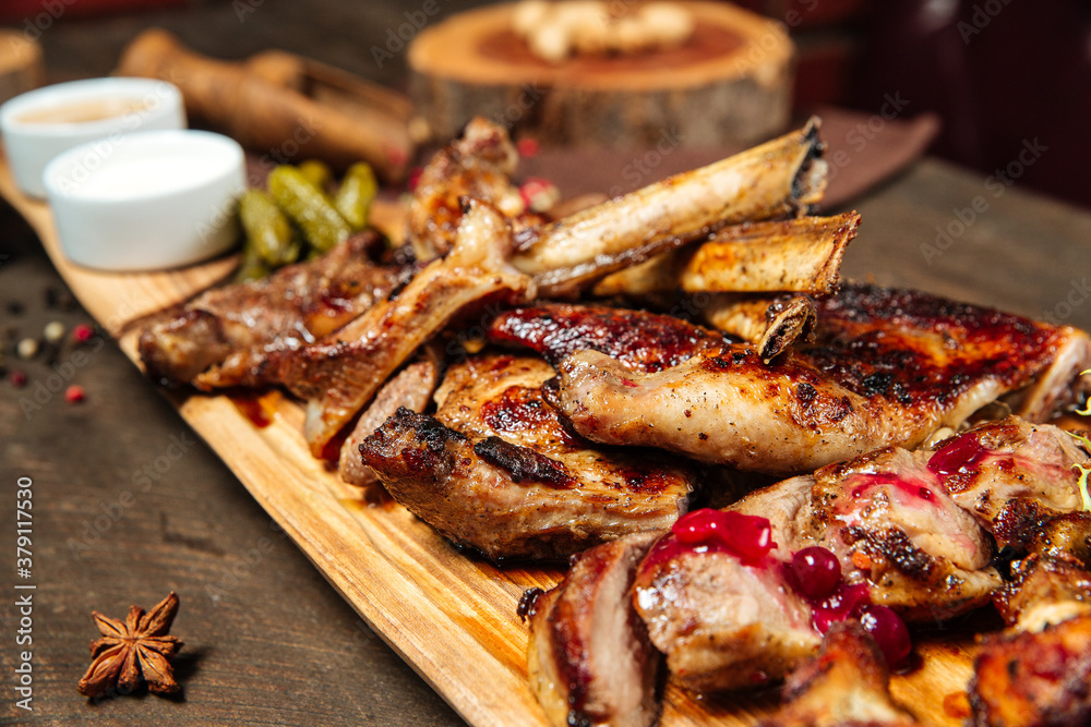 Assorted roasted meat set on the wooden board