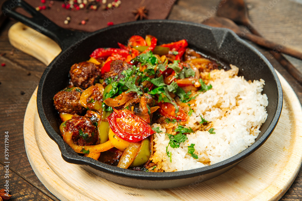 Beef with vegetables and rice in cast iron pan Beef with vegetables and rice in cast iron pan