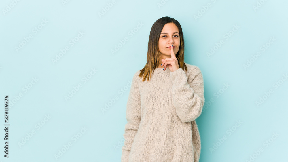 Young woman isolated on blue background thinking and looking up, being reflective, contemplating, having a fantasy. Young woman isolated on blue background thinking and looking up, being reflective, contemplating, having a fantasy.