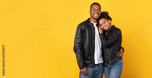 African Couple Hugging Posing Wearing Black Leather Jackets, Studio Shot © Prostock-studio