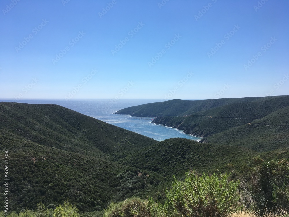 Mountain landscape on sunny summer day with clear sky in Greece with sea gulf on background